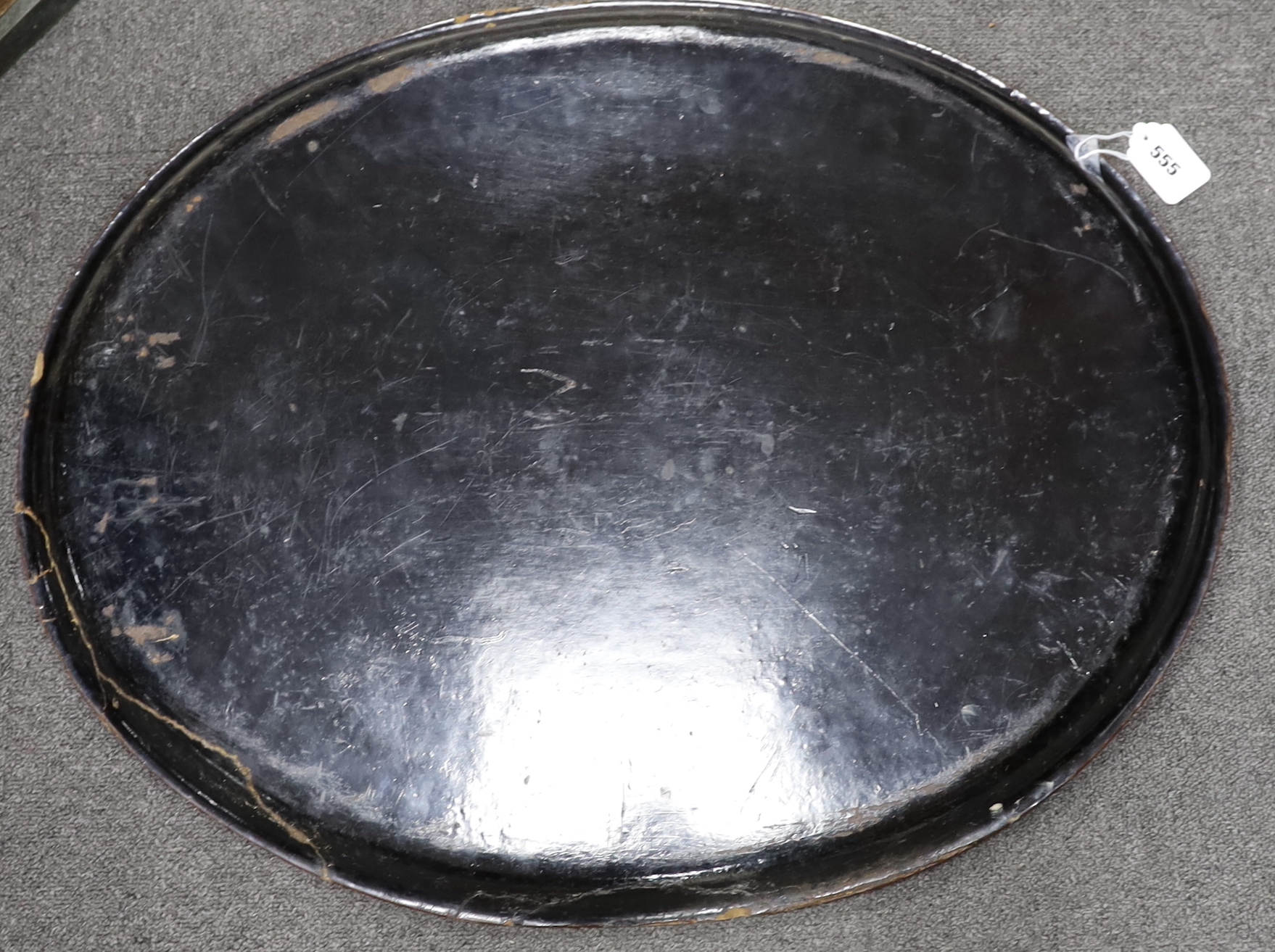 A large Victorian oval papier mache tray hand painted with flowers, 73cm wide